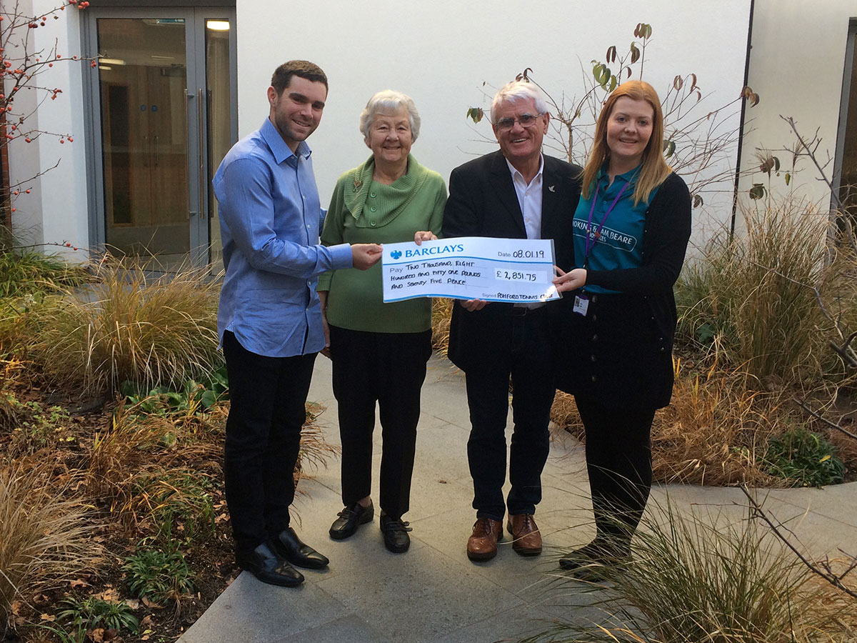 Ashford Tennis club present a cheque to the Sam Beare Hospice in Woking